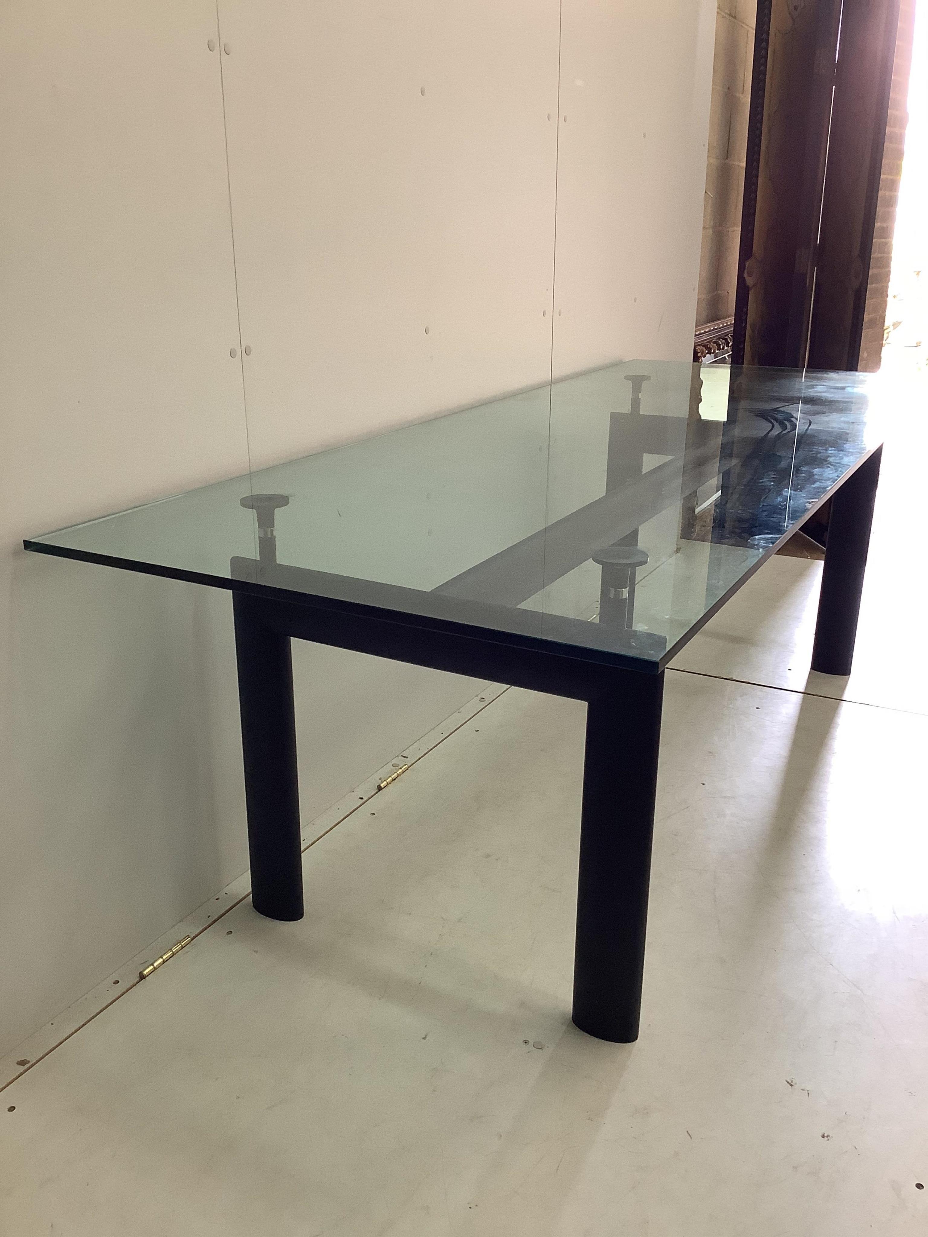 A Corbusier design LC6 style dining table with glass top, width 225cm, depth 85cm, height 72cm